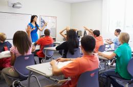 High school teacher in front of a classroom 
