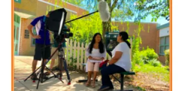 Filming an episode of the telenovela showing camera and two of the actors