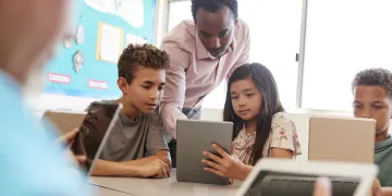Students and teacher on ipad
