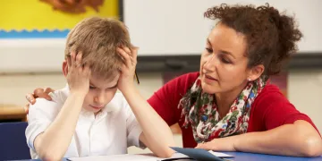 Teacher working with student looking frustrated