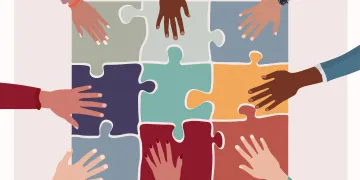 Hands putting together a puzzle