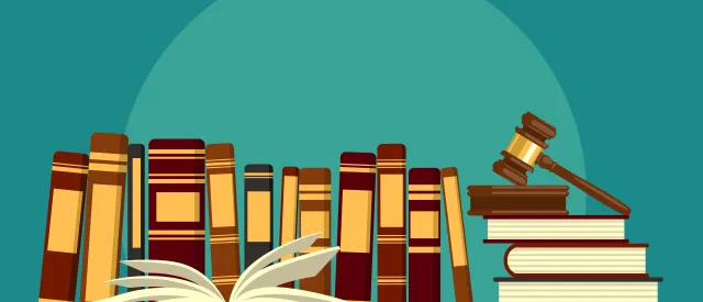 Books on bookshelf with gavel