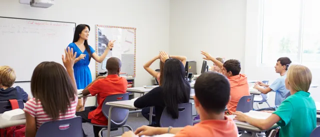 High school teacher in front of a classroom 