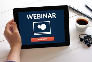 Hand holding an iPad that says Webinar Join Now