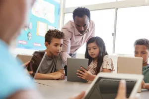 Students and teacher on ipad