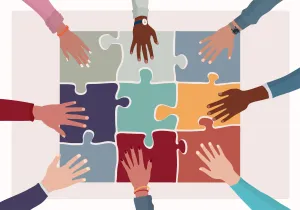 Hands putting together a puzzle